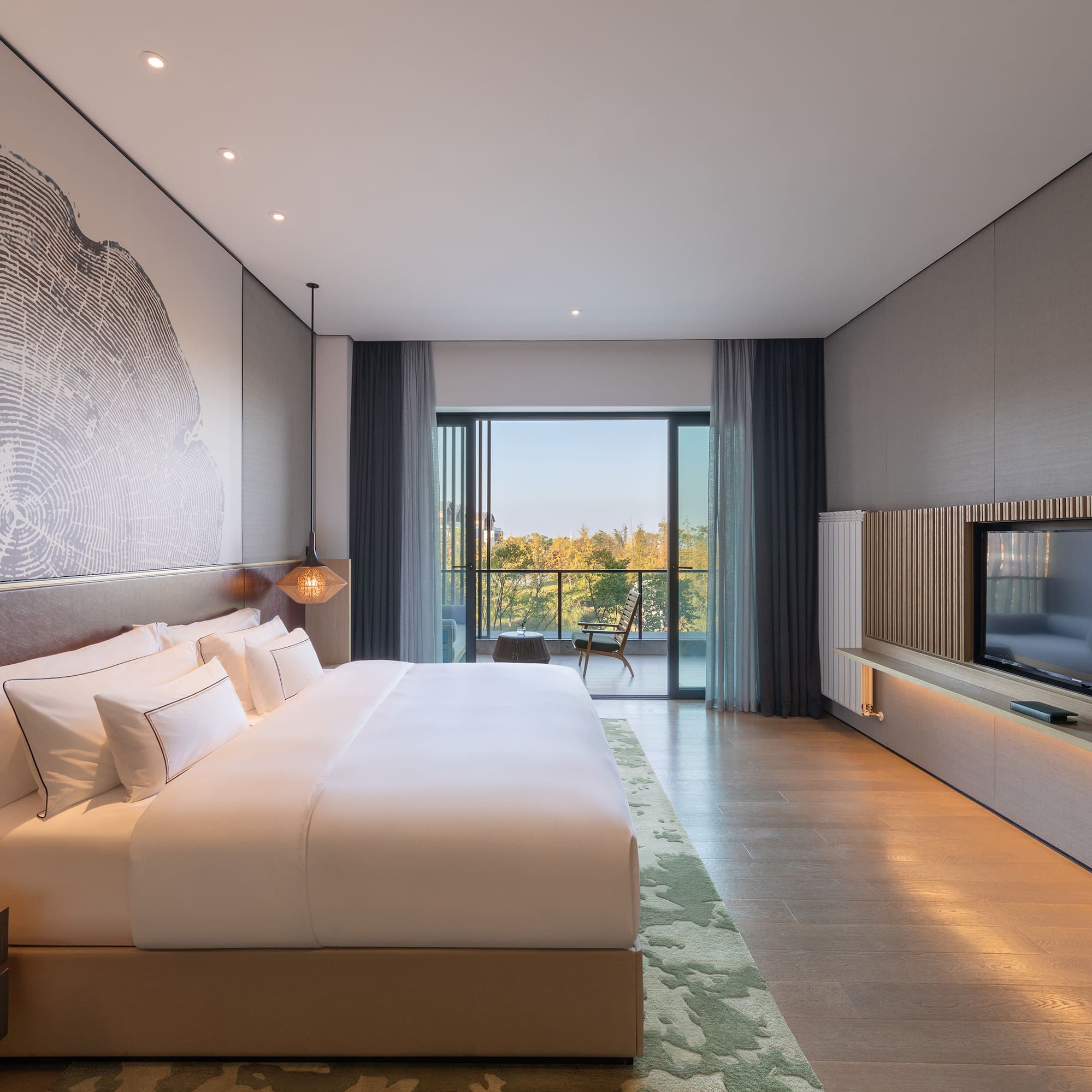 a bedroom with a large bed and a television