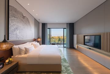 a bedroom with a large bed and a television
