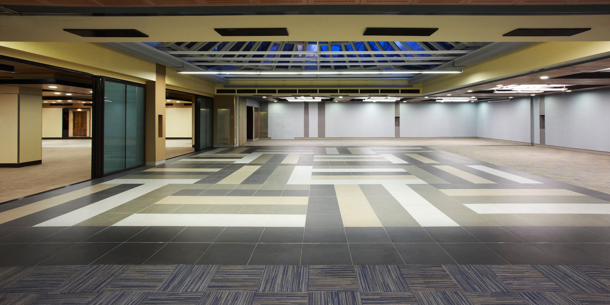 a large empty room with a tile floor
