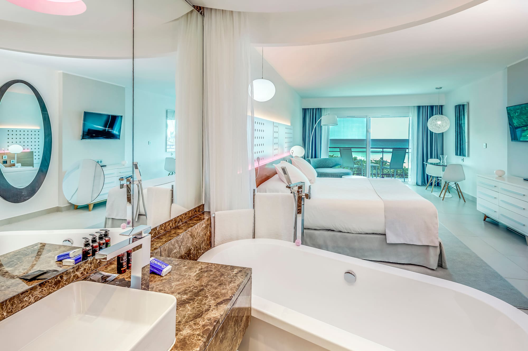 a bathroom with a bathtub and a bed