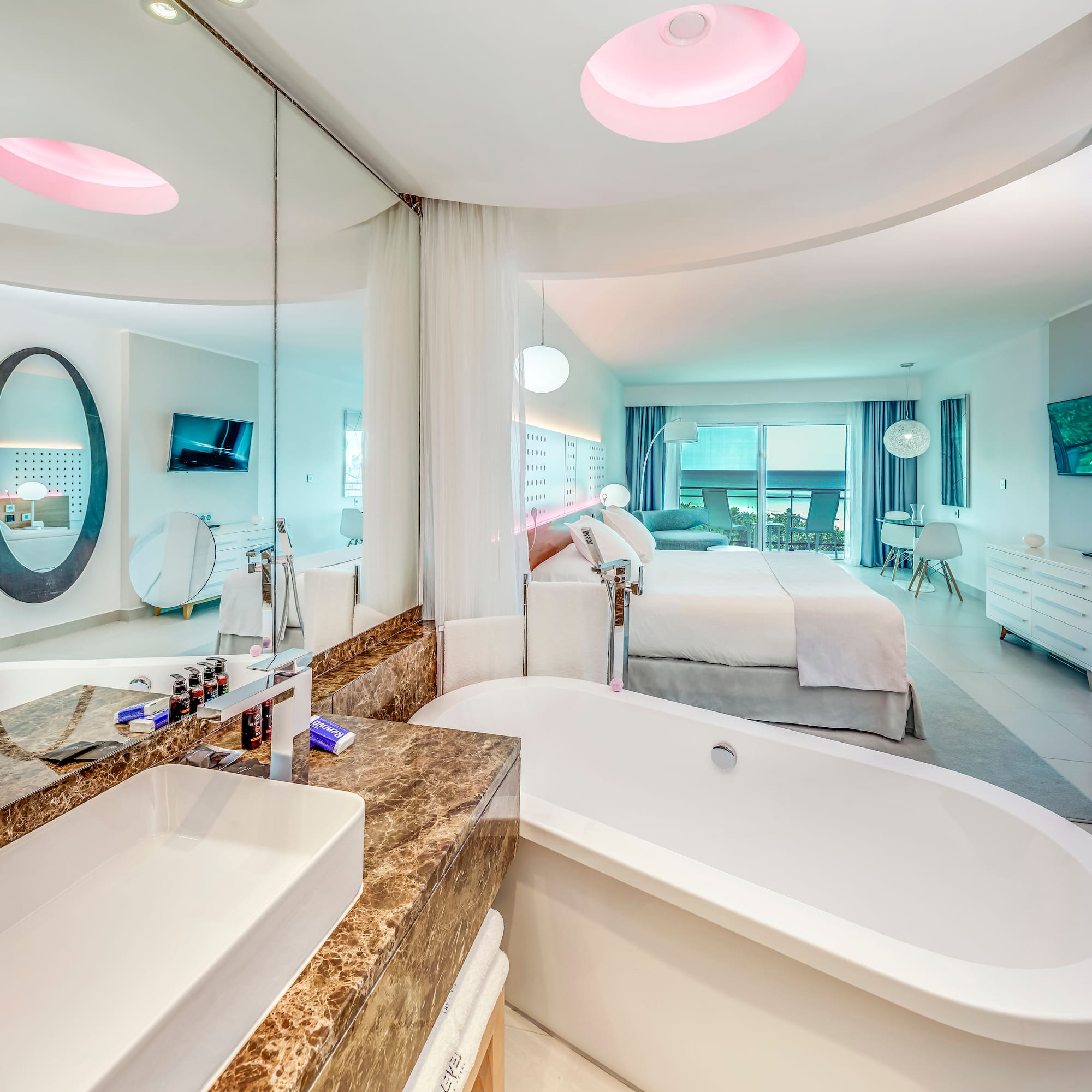 a bathroom with a bathtub and a bed
