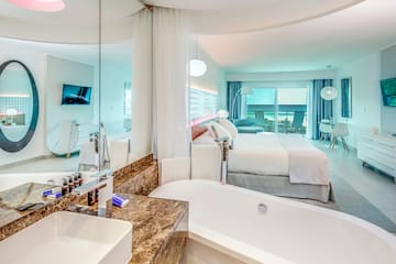 a bathroom with a bathtub and a bed