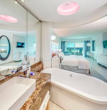 a bathroom with a bathtub and a bed