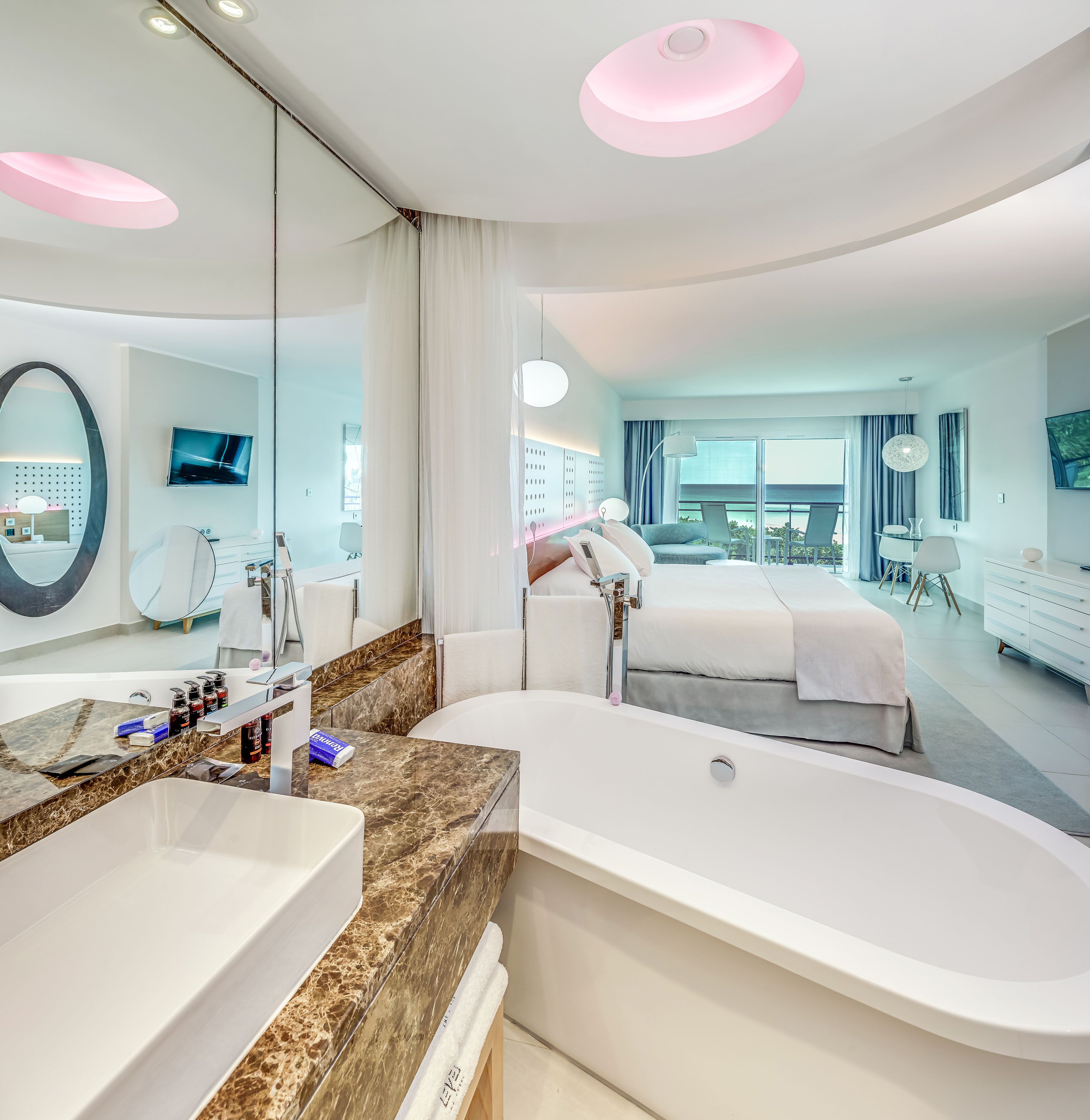 a bathroom with a bathtub and a bed