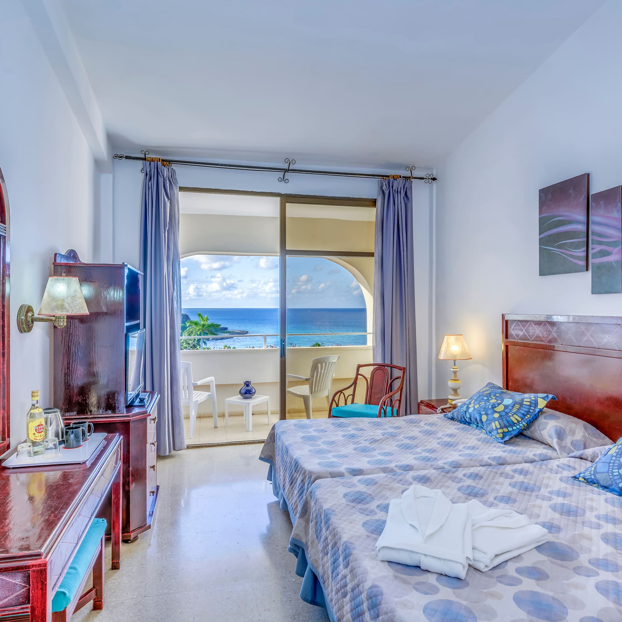 a bedroom with a large bed and a television