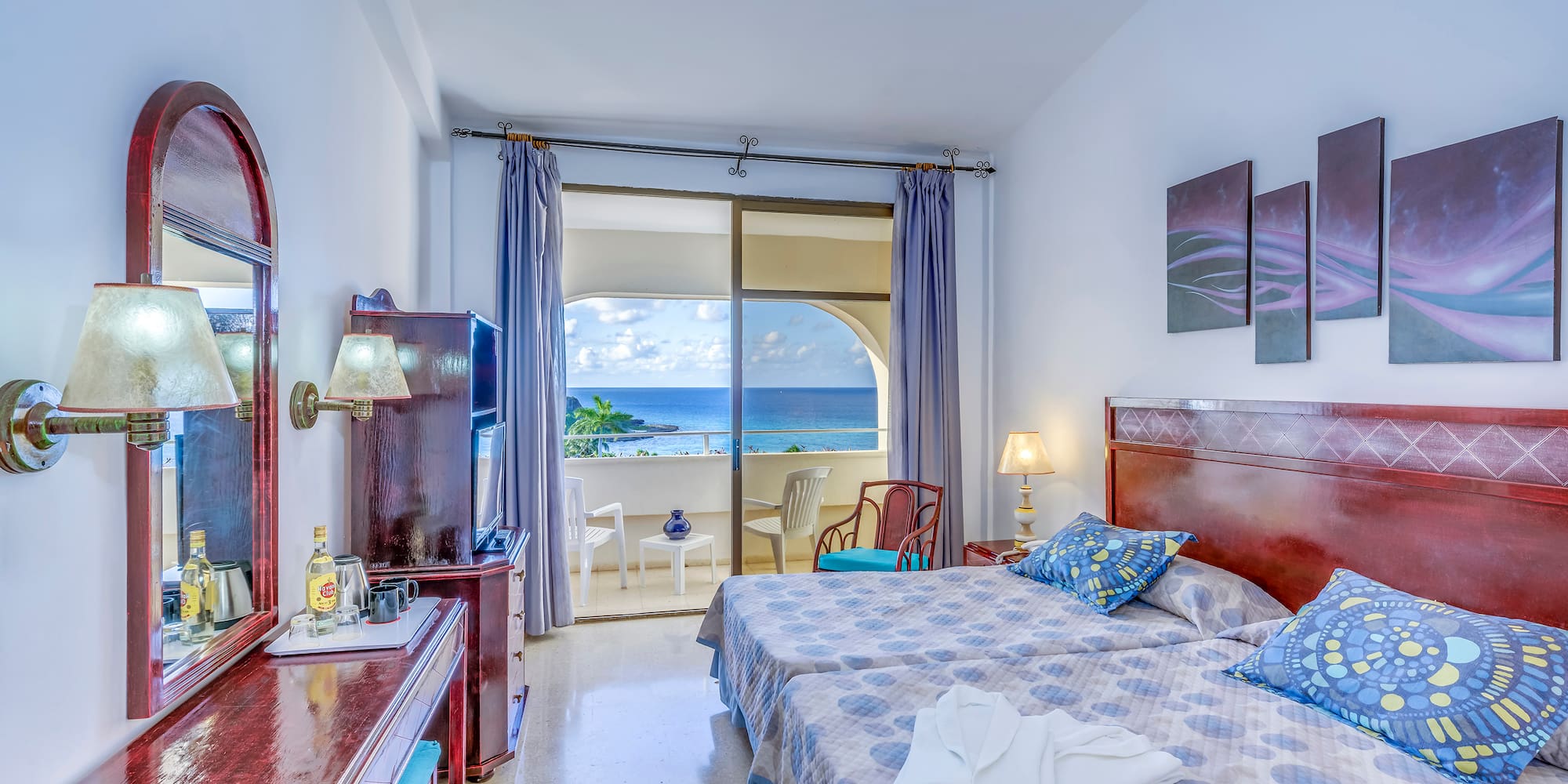 a bedroom with a large bed and a television