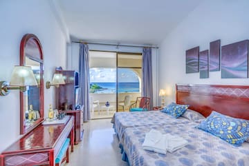 a bedroom with a large bed and a television
