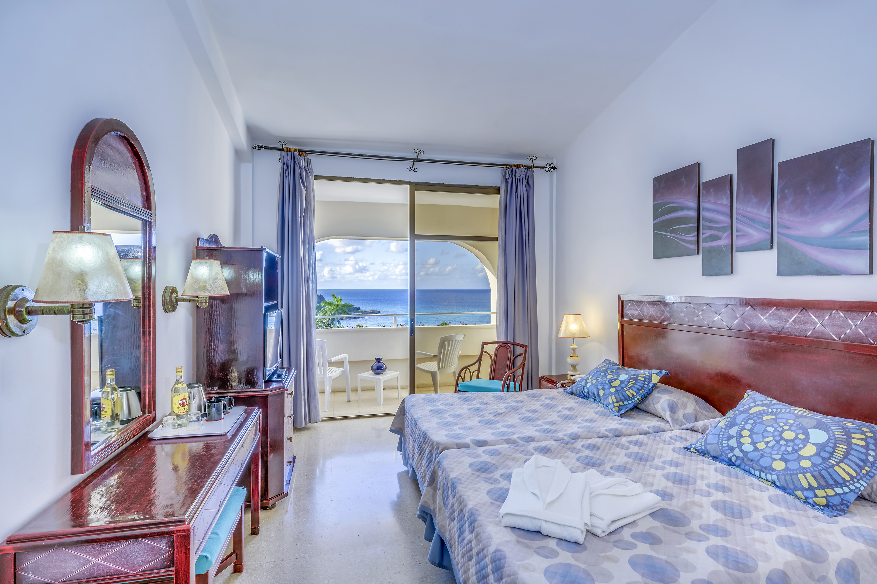 a bedroom with a large bed and a television