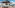 Luxury rooftop terrace with thatched gazebo daybed, hot tub, and ocean view.