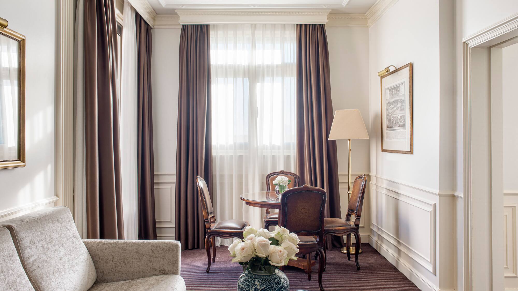 a room with a couch and chairs