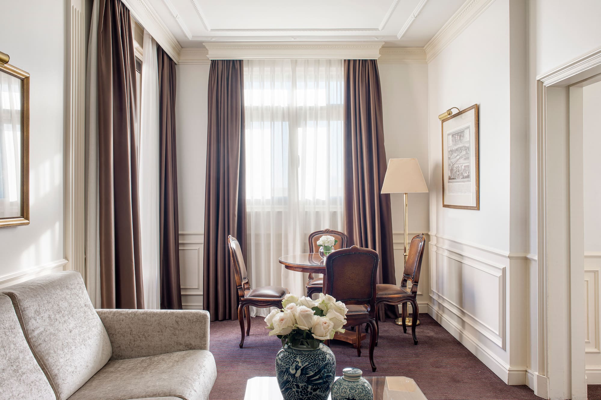 a room with a couch and chairs