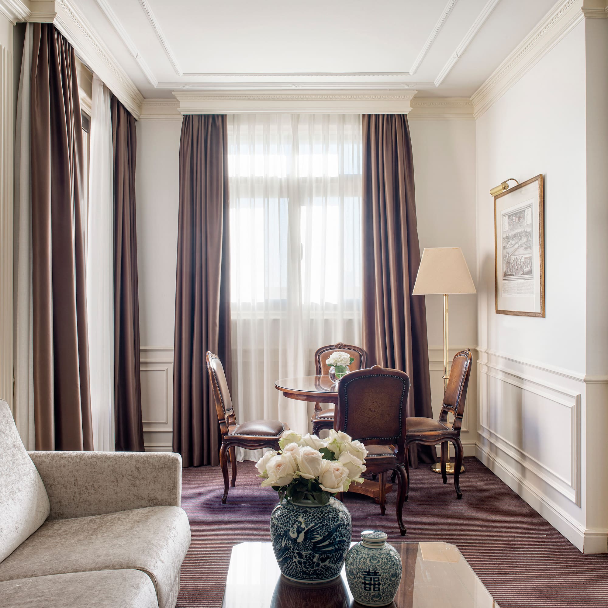 a room with a couch and chairs