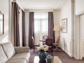 a room with a couch and chairs