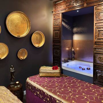 a room with a bed and a bathtub