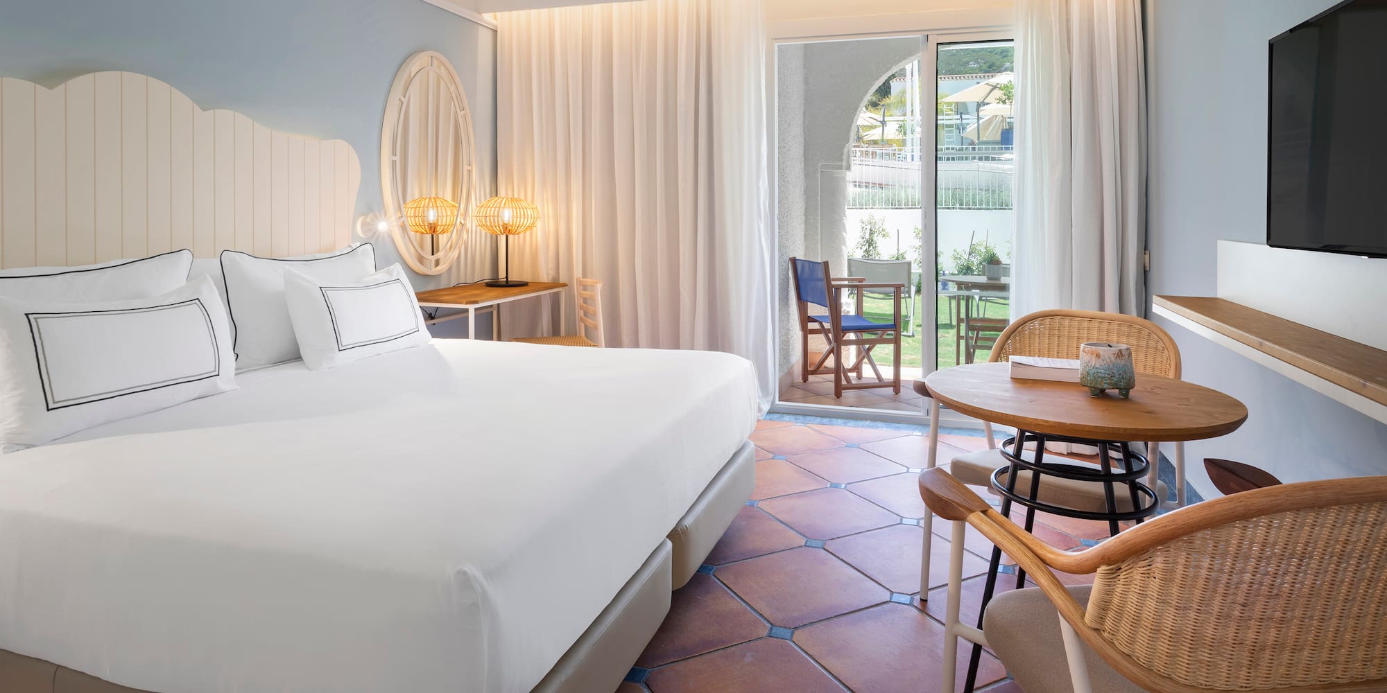 a room with a bed and chairs