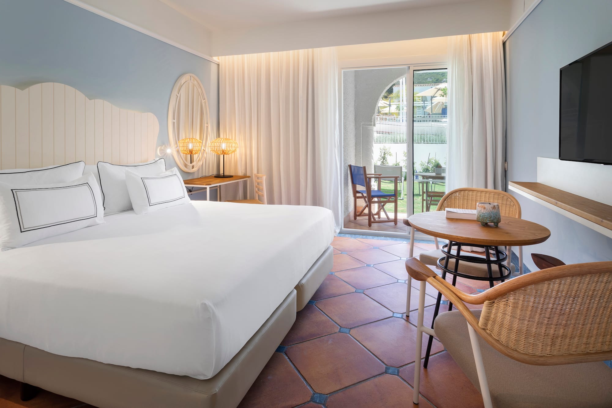 a room with a bed and chairs