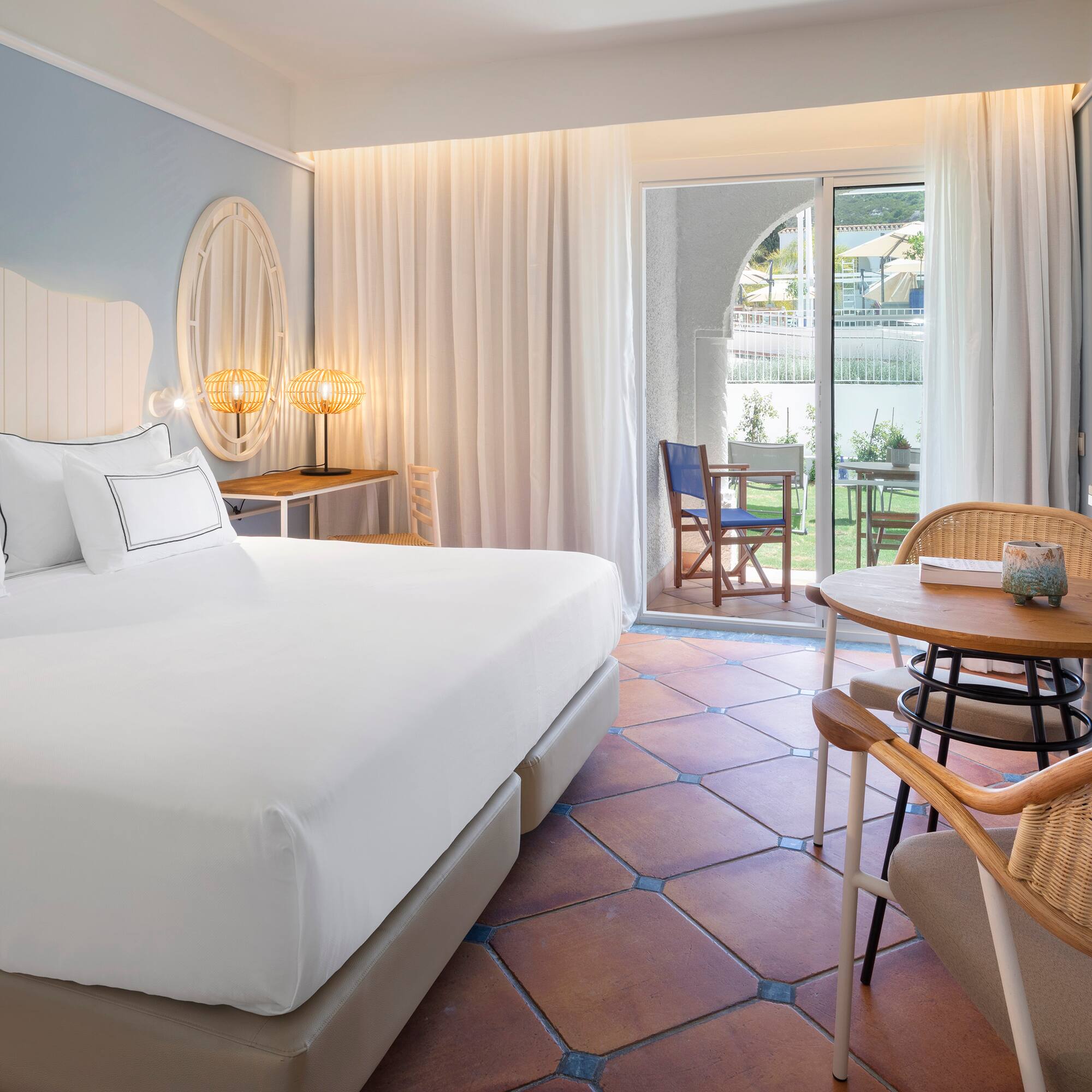 a room with a bed and chairs