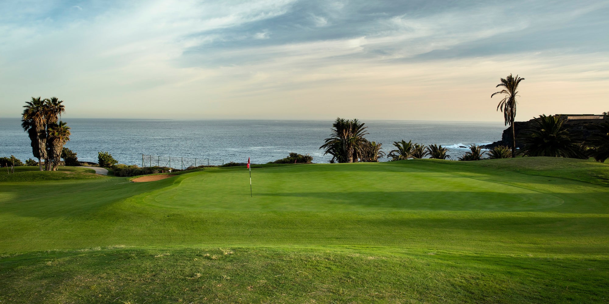 a golf course with a flag on the grass