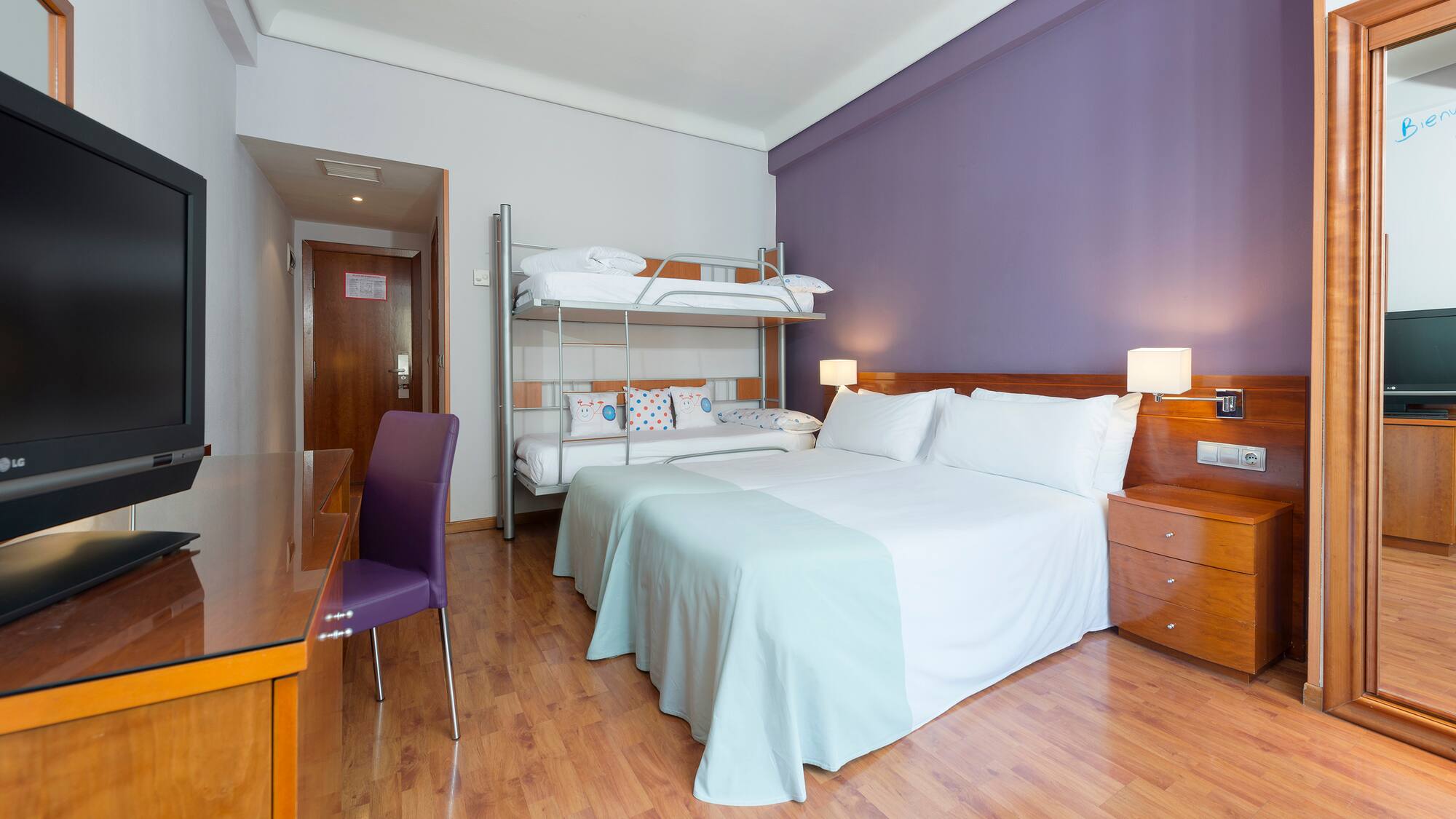 a room with a bed and a desk