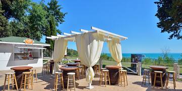 a patio with tables and chairs