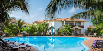a pool with lounge chairs and palm trees