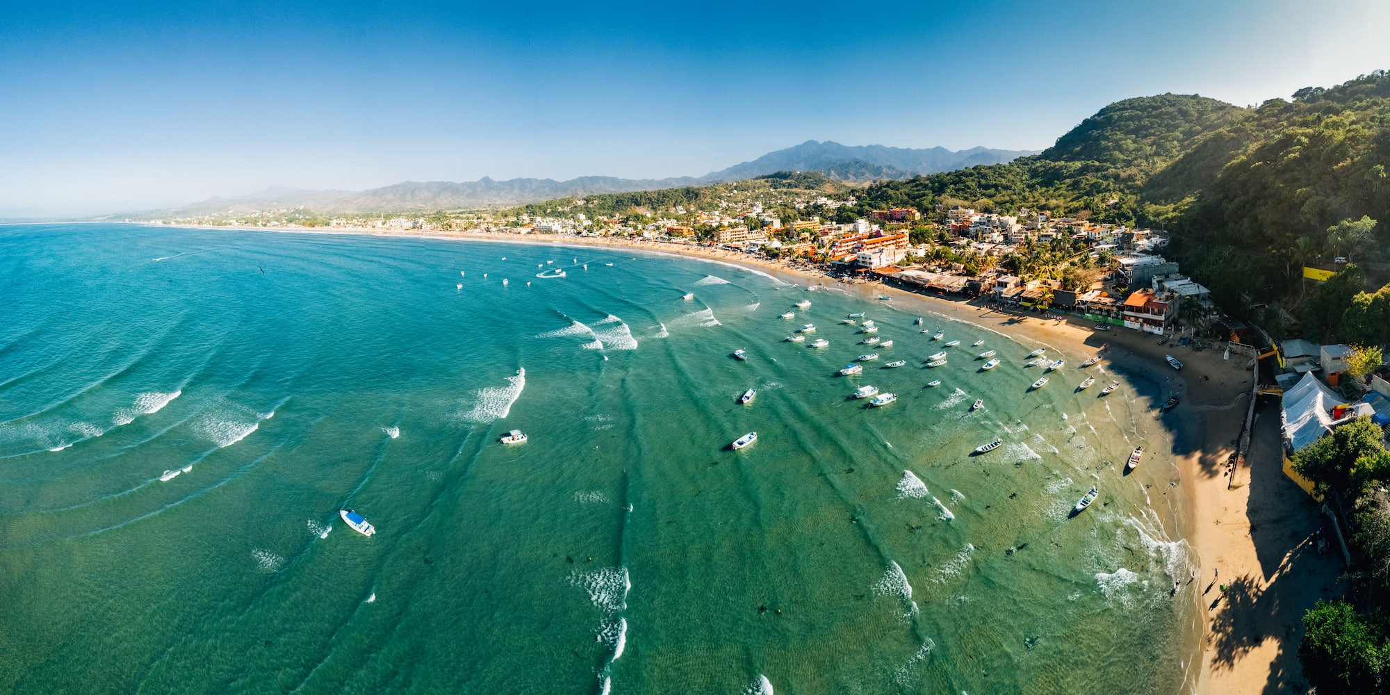 boats on the water near a beach