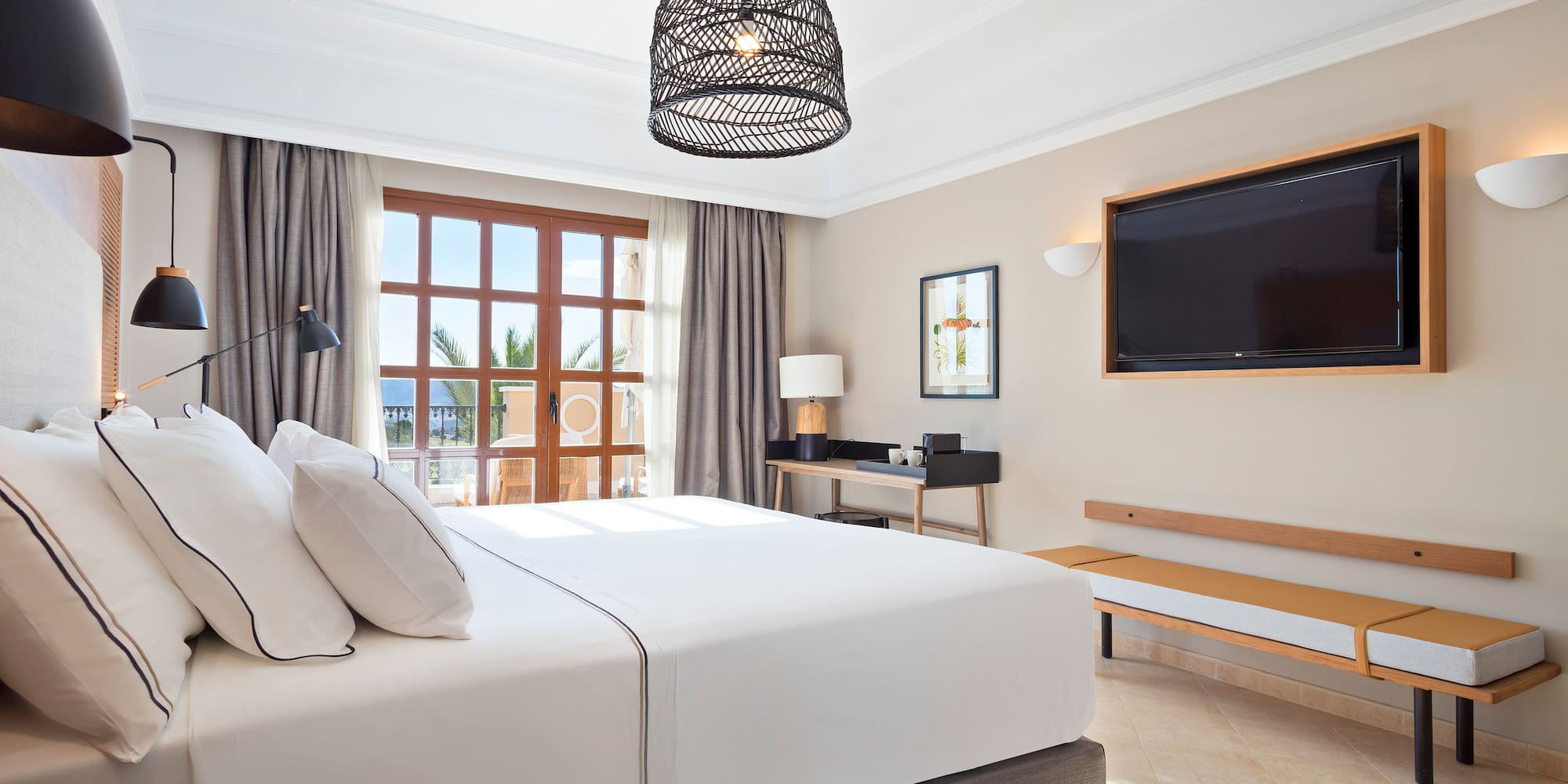 a bedroom with a large bed and a television