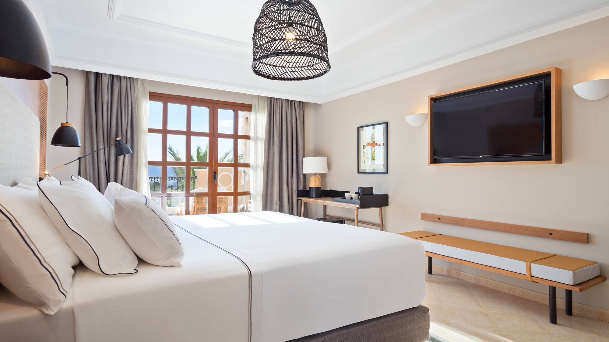 a bedroom with a large bed and a television