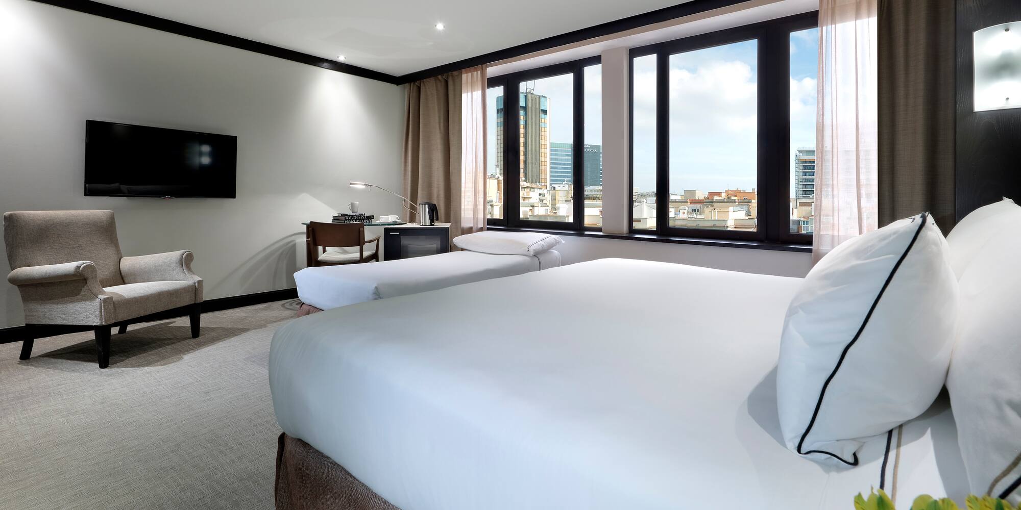 a room with two beds and a television