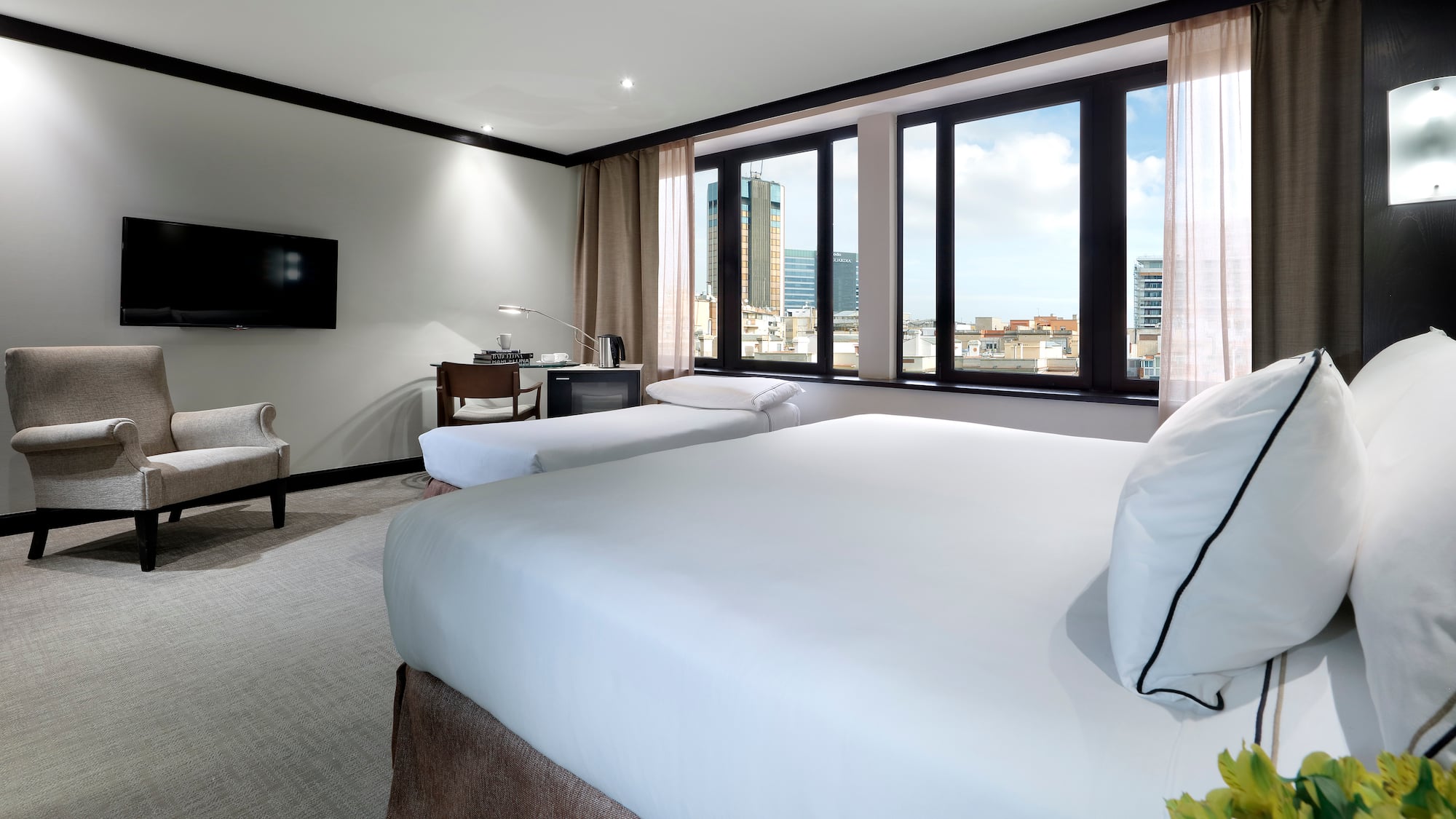 a room with two beds and a television