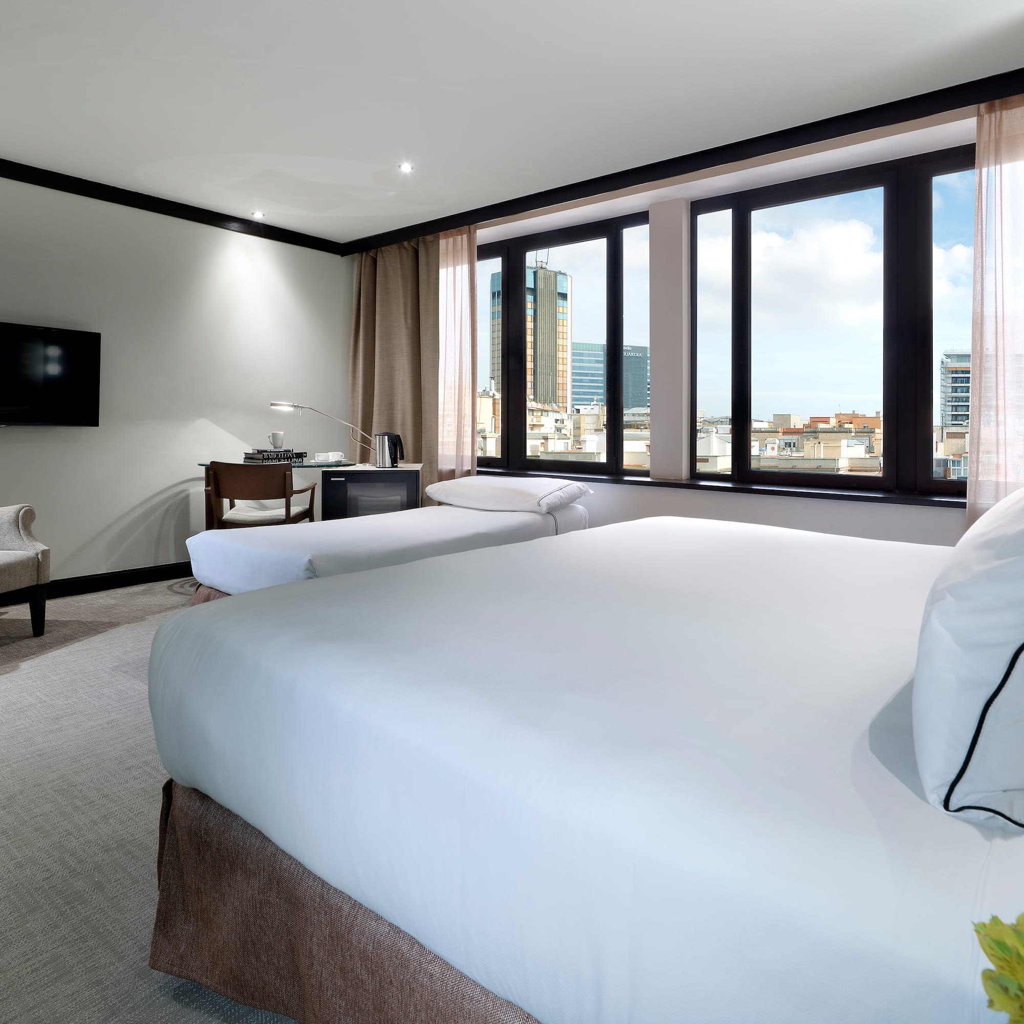 a room with two beds and a television