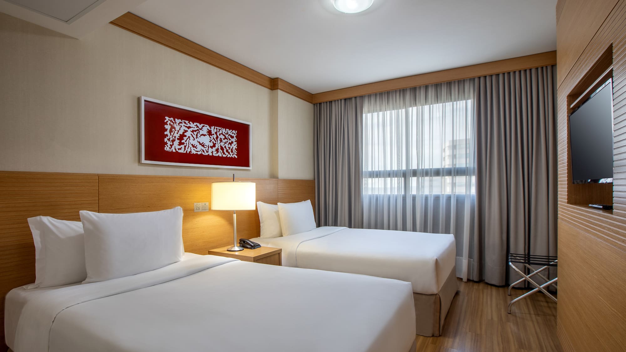 a room with two beds and a lamp