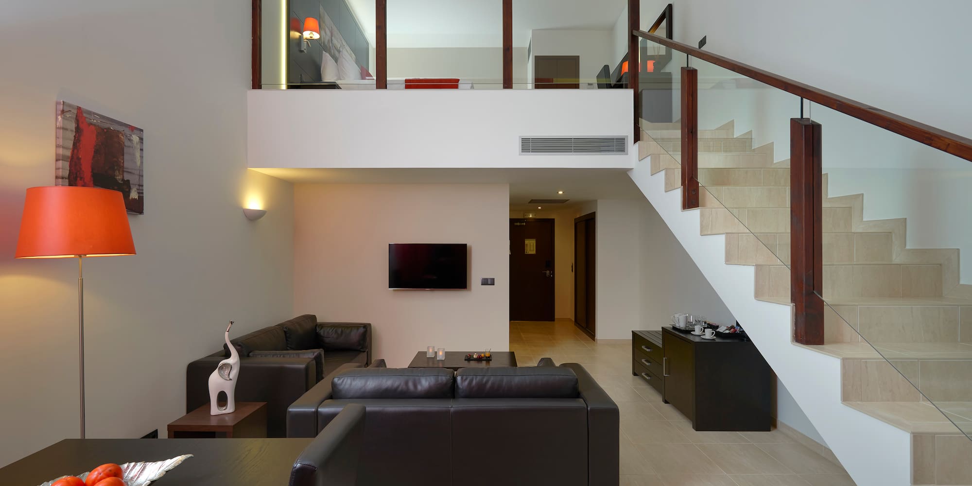 a living room with a staircase and a couch