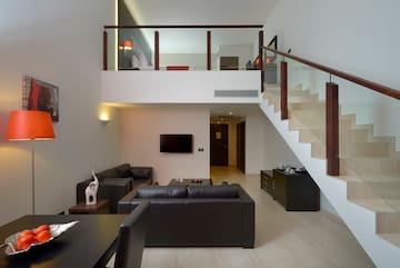 a living room with a staircase and a couch