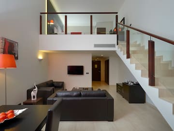 a living room with a staircase and a couch