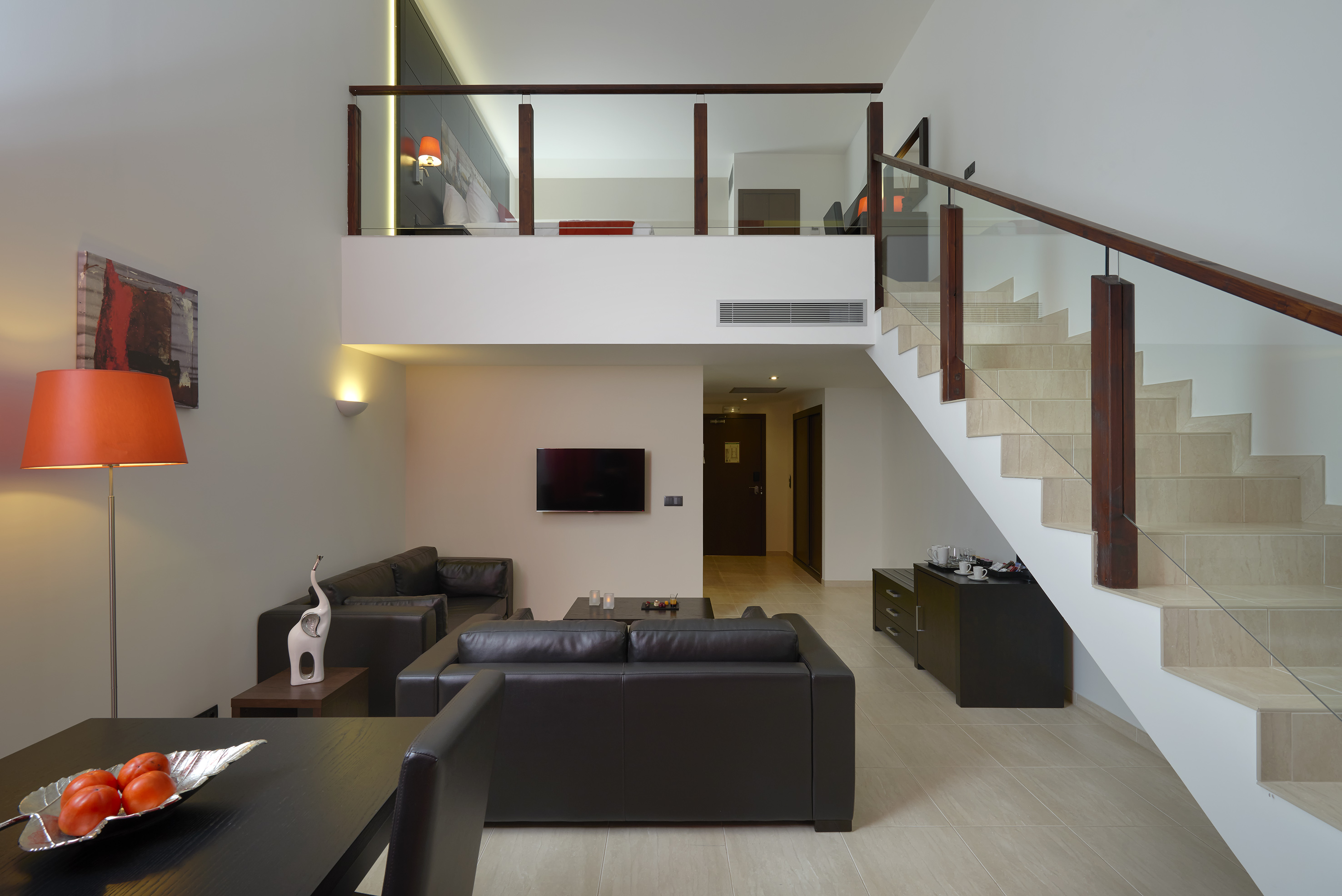 a living room with a staircase and a couch