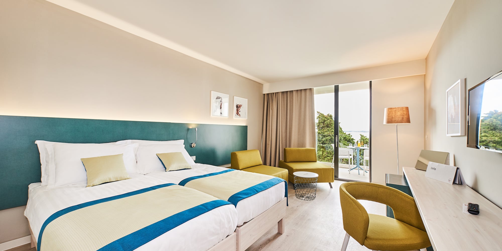 a room with a bed and chairs