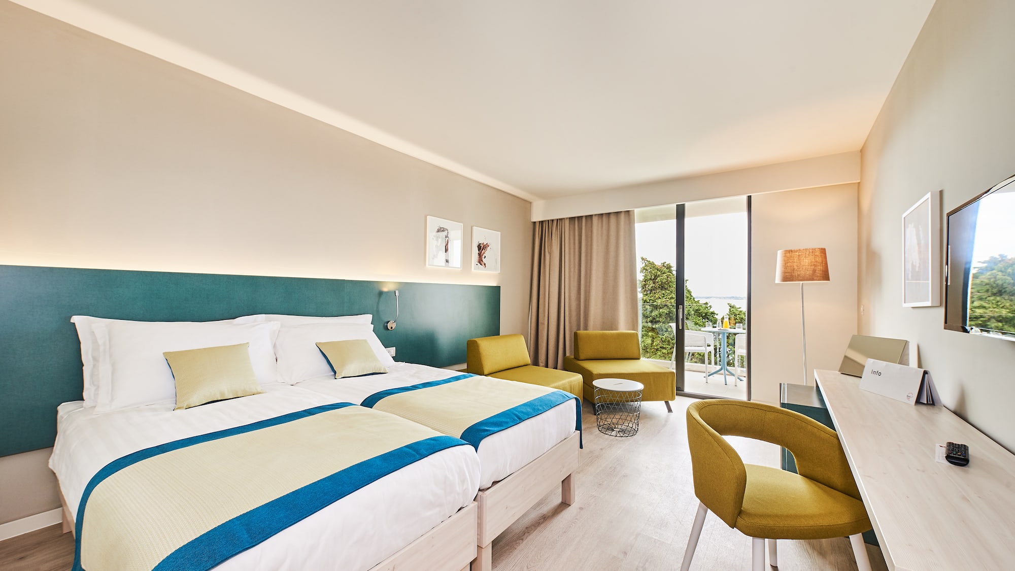 a room with a bed and chairs