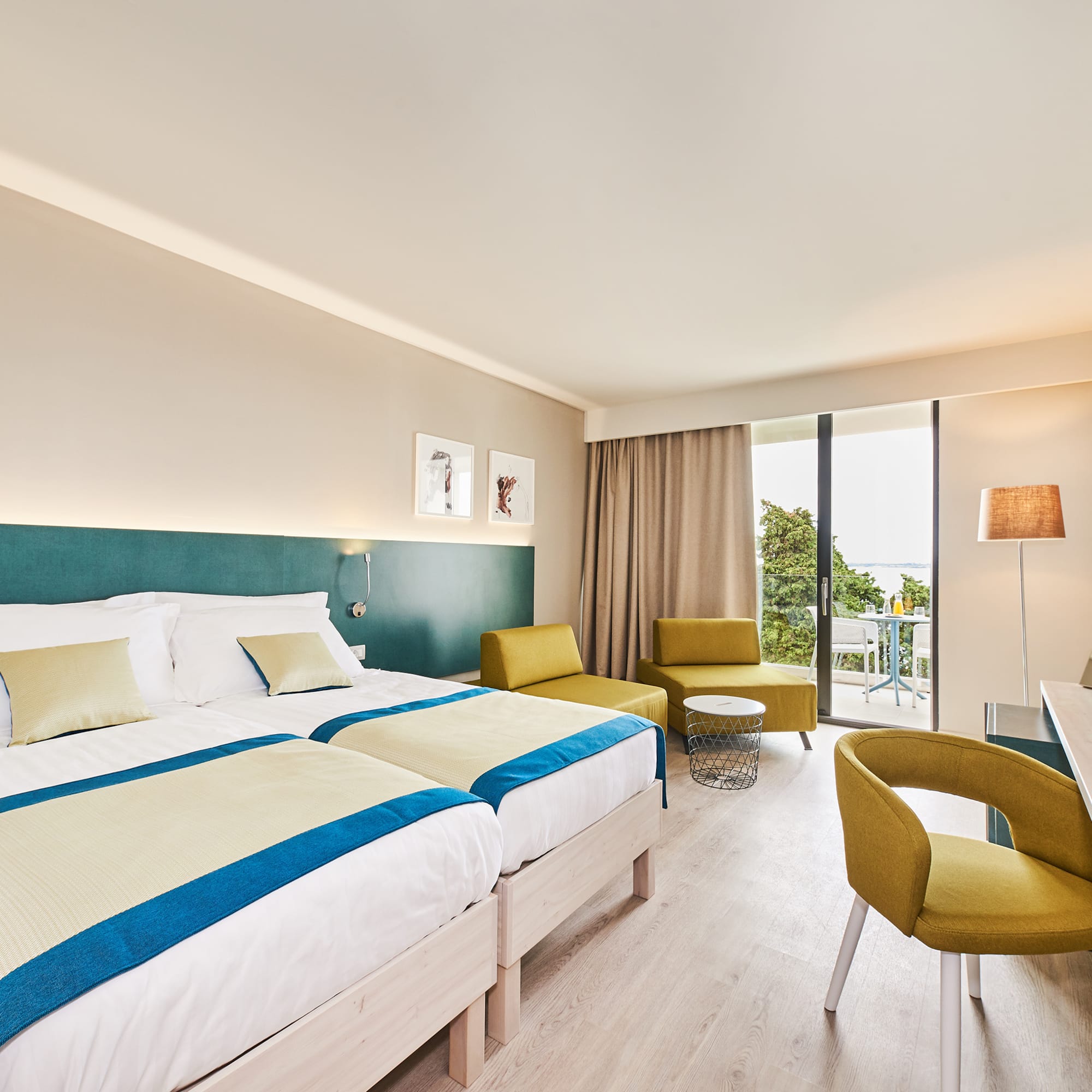 a room with a bed and chairs