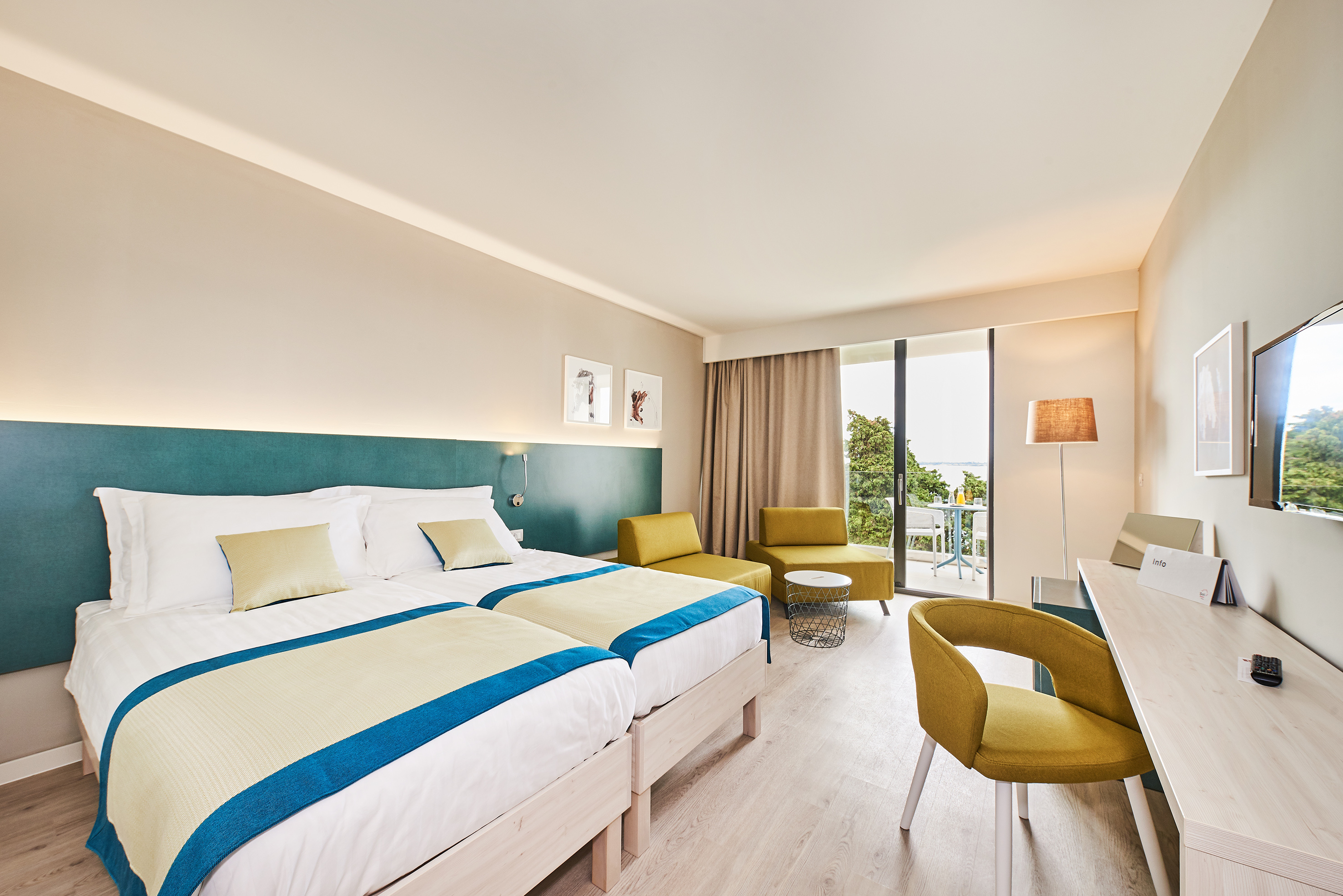 a room with a bed and chairs