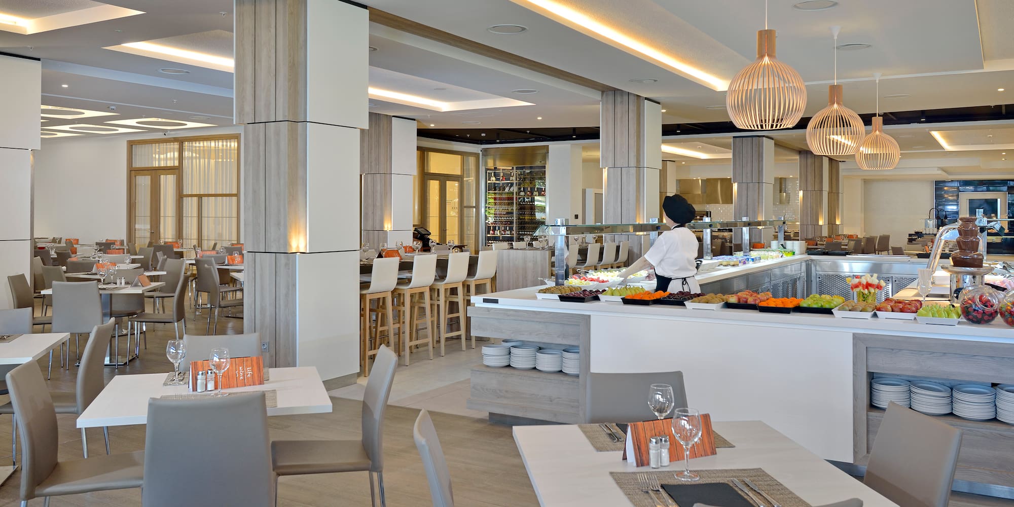 a restaurant with a chef behind a counter