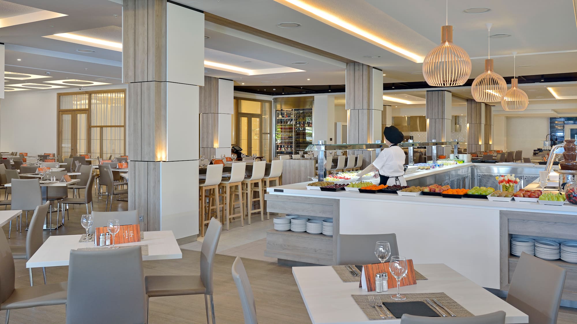 a restaurant with a chef behind a counter