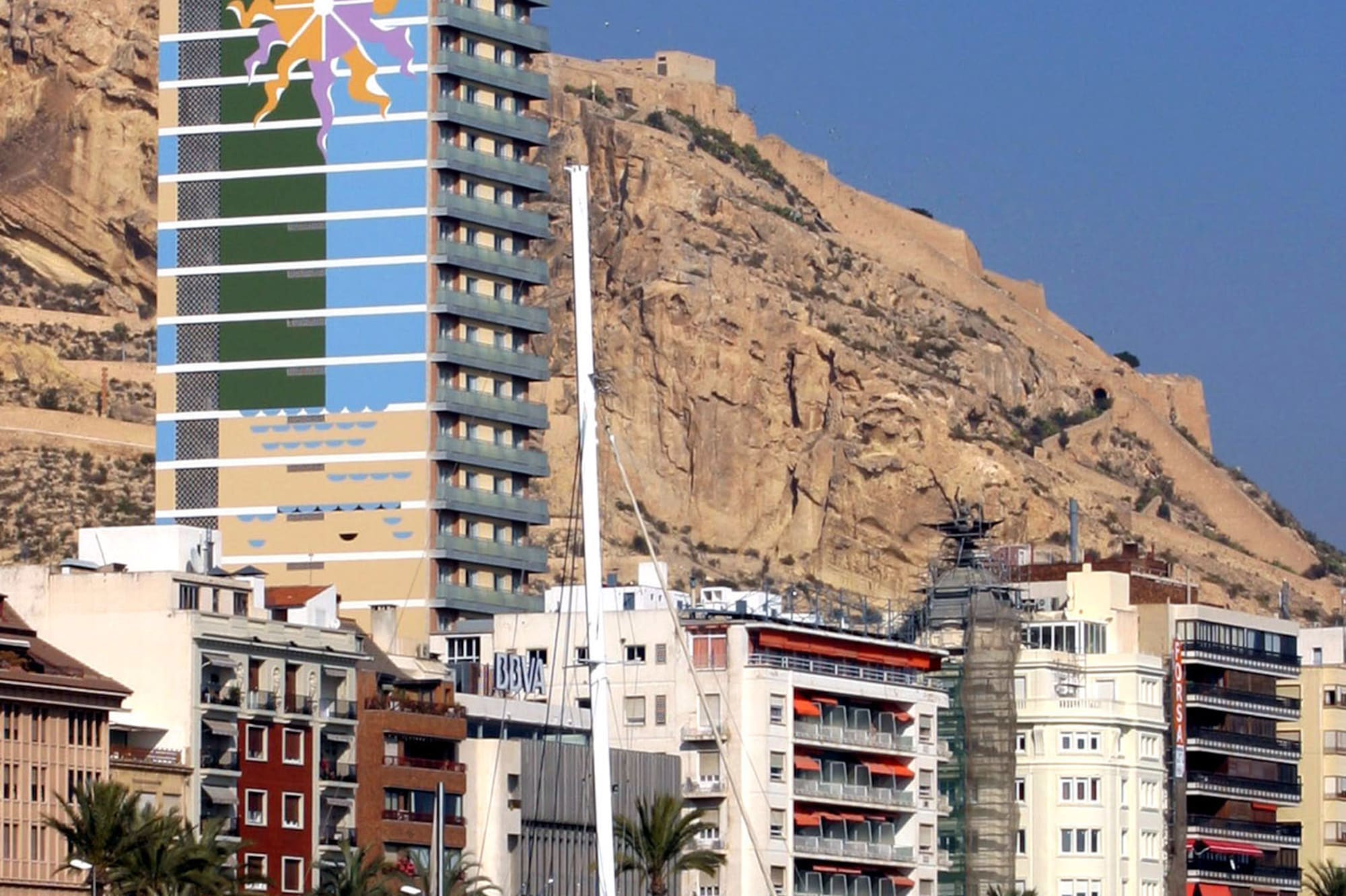 Gran Sol Hotel, Santa Bárbara Castle, and catamaran in Alicante port.