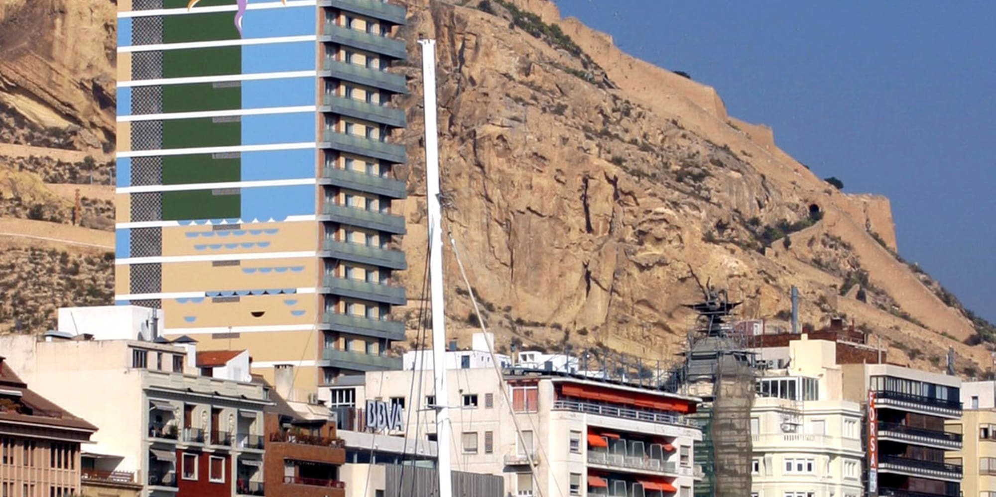 a tall building with a large mural on the side of it