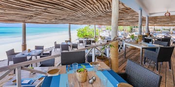 a restaurant with tables and chairs on a beach