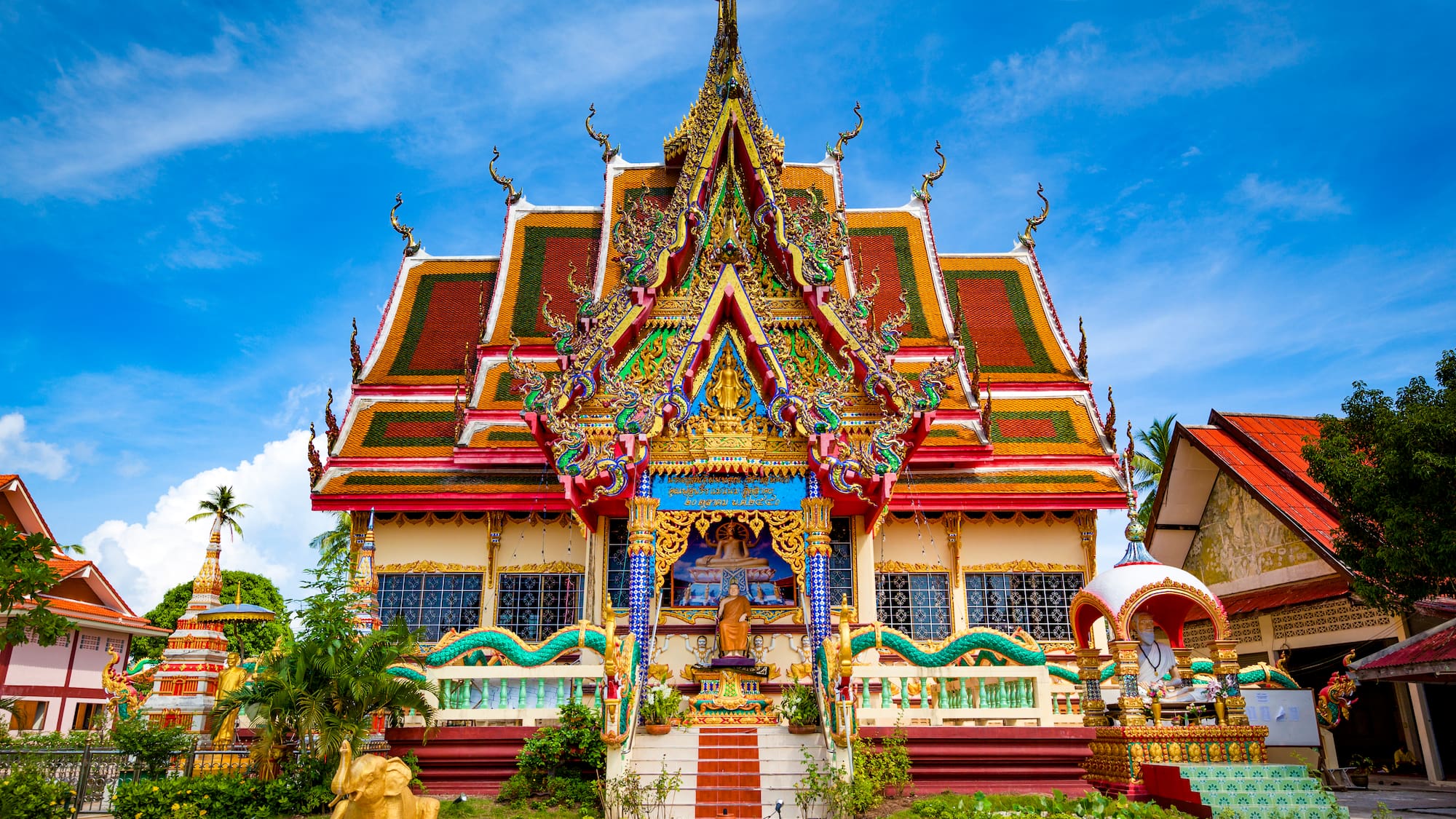 a colorful building with a statue on the front