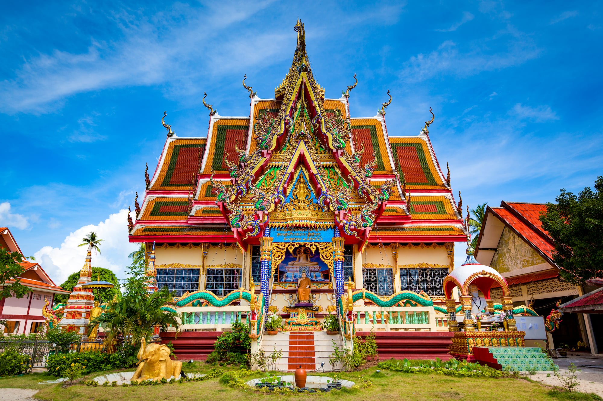 a colorful building with a statue on the front