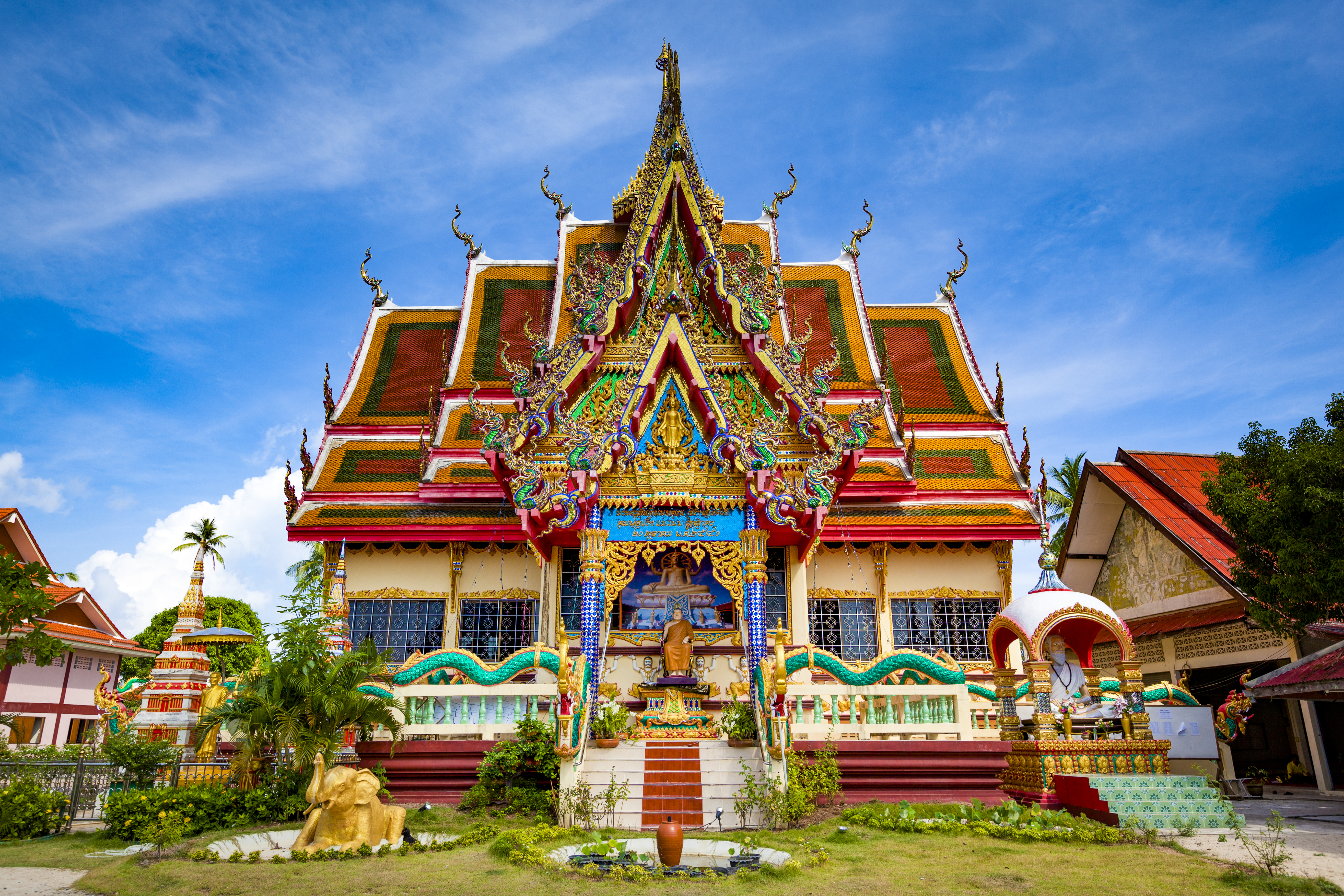a colorful building with a statue on the front
