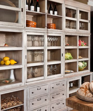 a cabinet with shelves and food on it