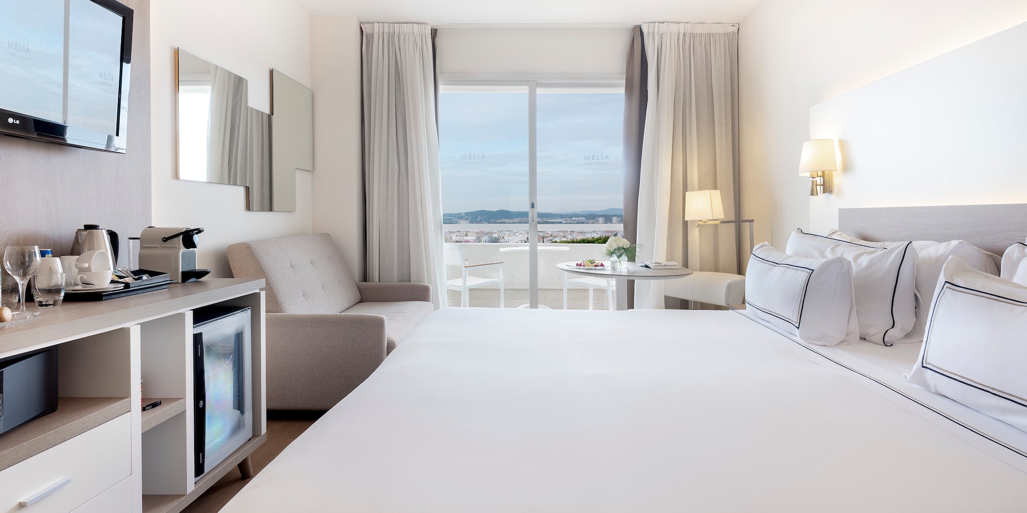 a room with a bed and a television